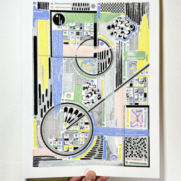 Hand holding a colorful abstract art print featuring intricate geometric shapes and patterns in pastel shades of blue, yellow, green, pink, and black. The artwork includes circles, grids, and lines, creating a dynamic and detailed composition.