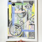 Hand holding a colorful abstract art print featuring intricate geometric shapes and patterns in pastel shades of blue, yellow, green, pink, and black. The artwork includes circles, grids, and lines, creating a dynamic and detailed composition.